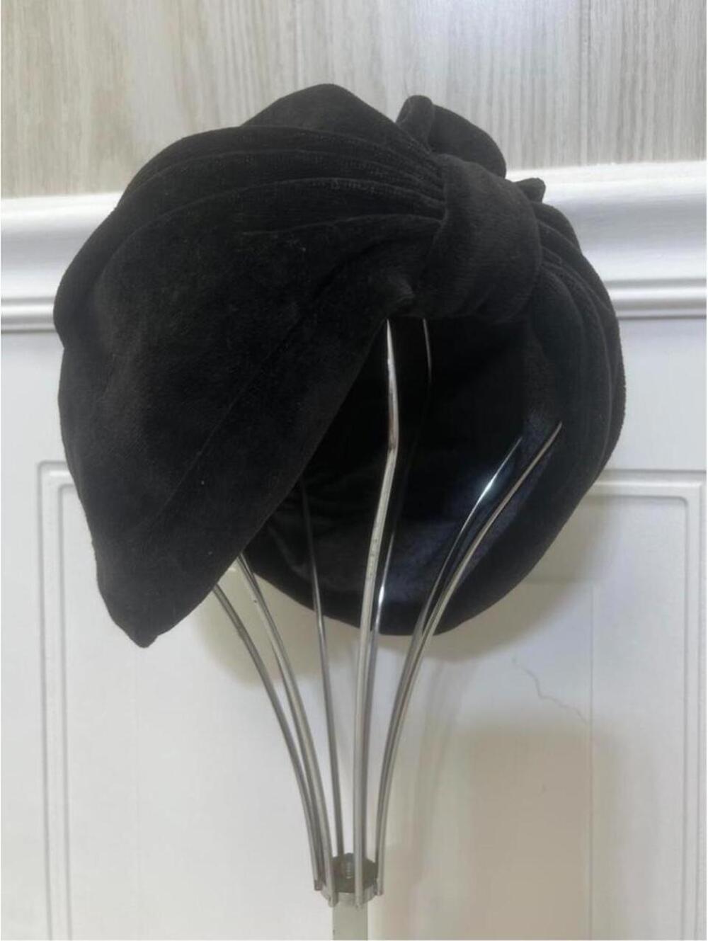 Vintage 1940s-1950s black velvet turban with knotted pleats and a tapered shape.